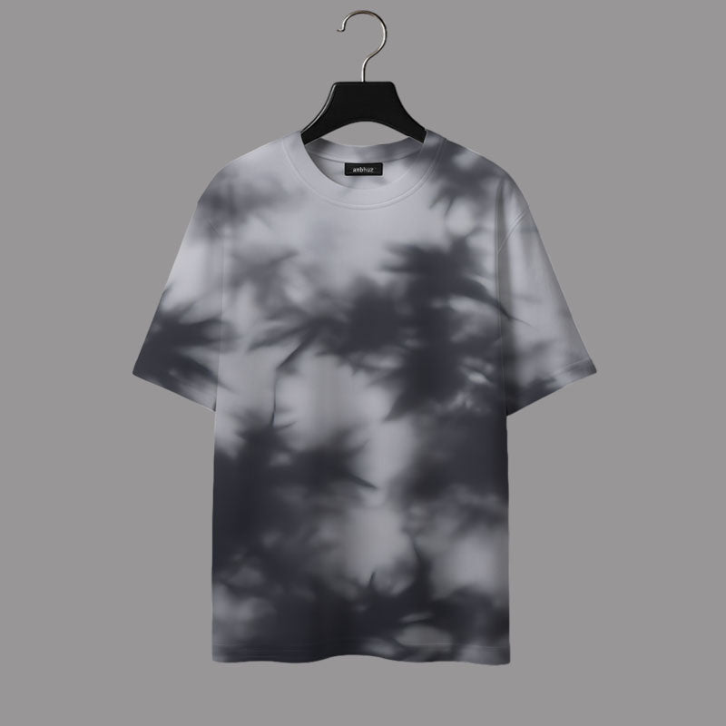 T-shirt with leaf shadow pattern on a hanger against a gray background