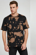 Man wearing a black t-shirt with brown abstract pattern on a white background
