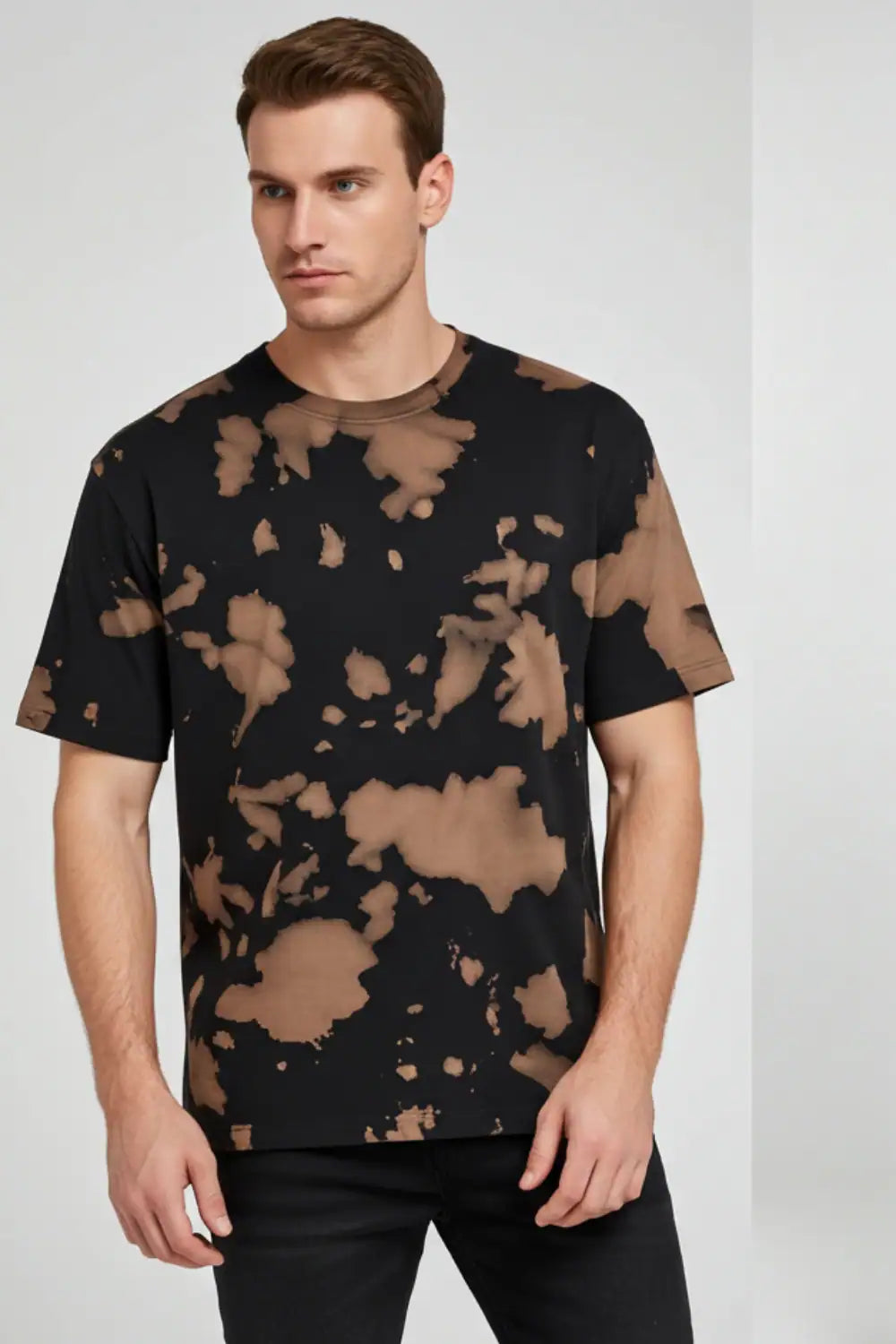 Man wearing a black t-shirt with brown abstract pattern on a white background