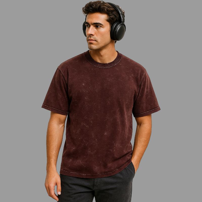 Man wearing a brown t-shirt and black headphones on a gray background