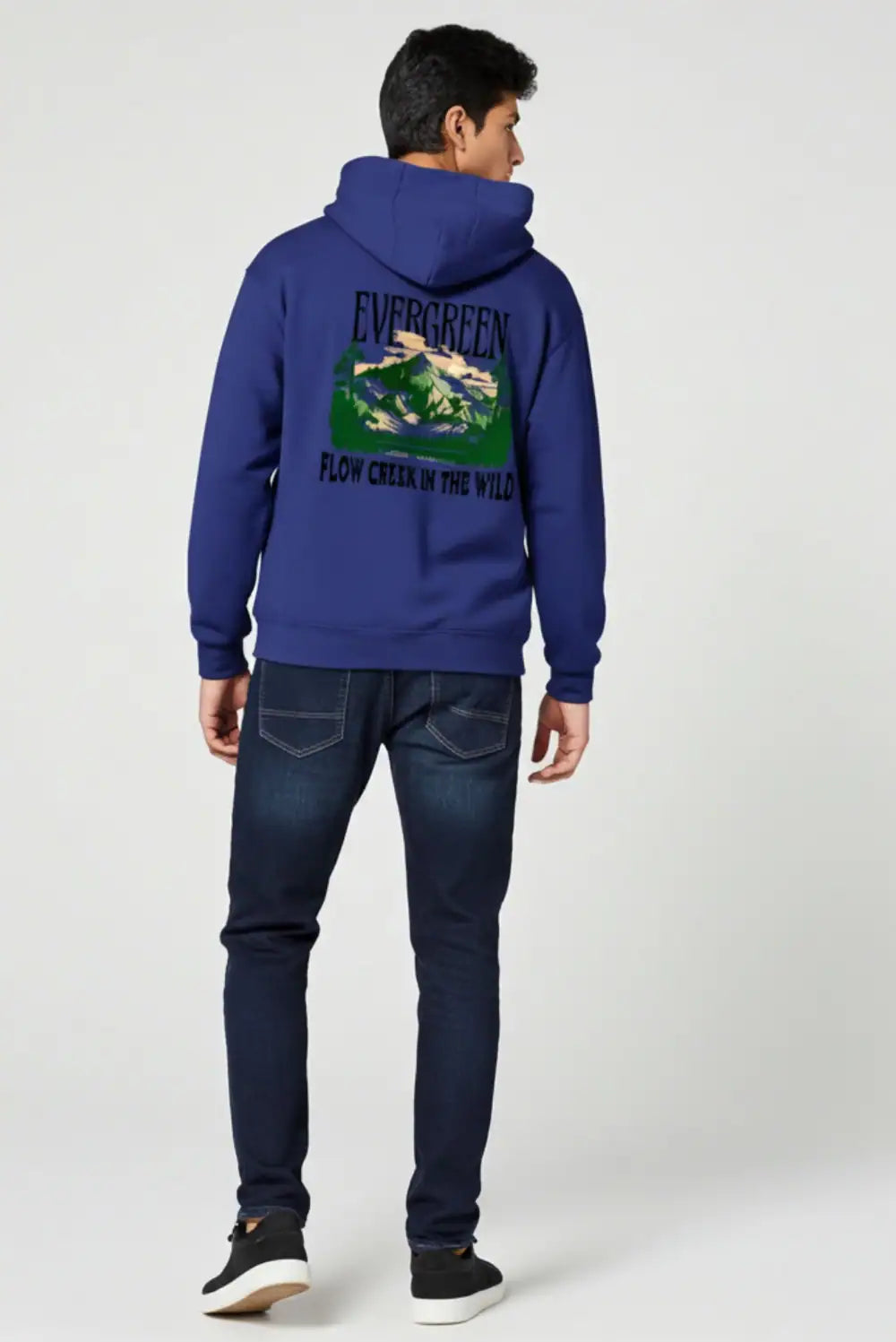 Person wearing a blue hoodie with a nature graphic on the back against a white background