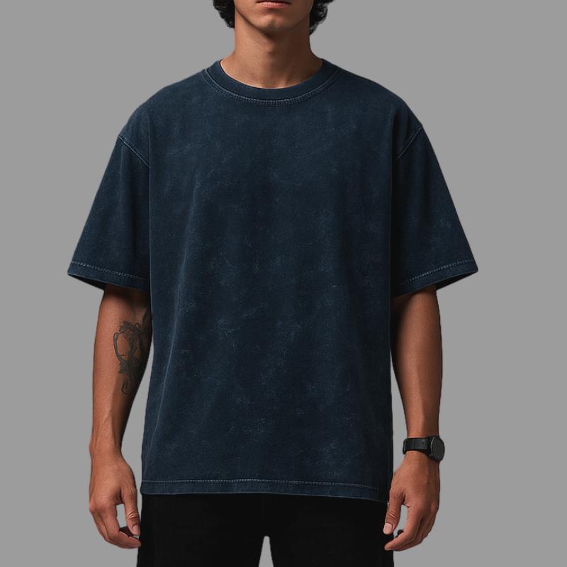 Person wearing a dark blue t-shirt against a gray background