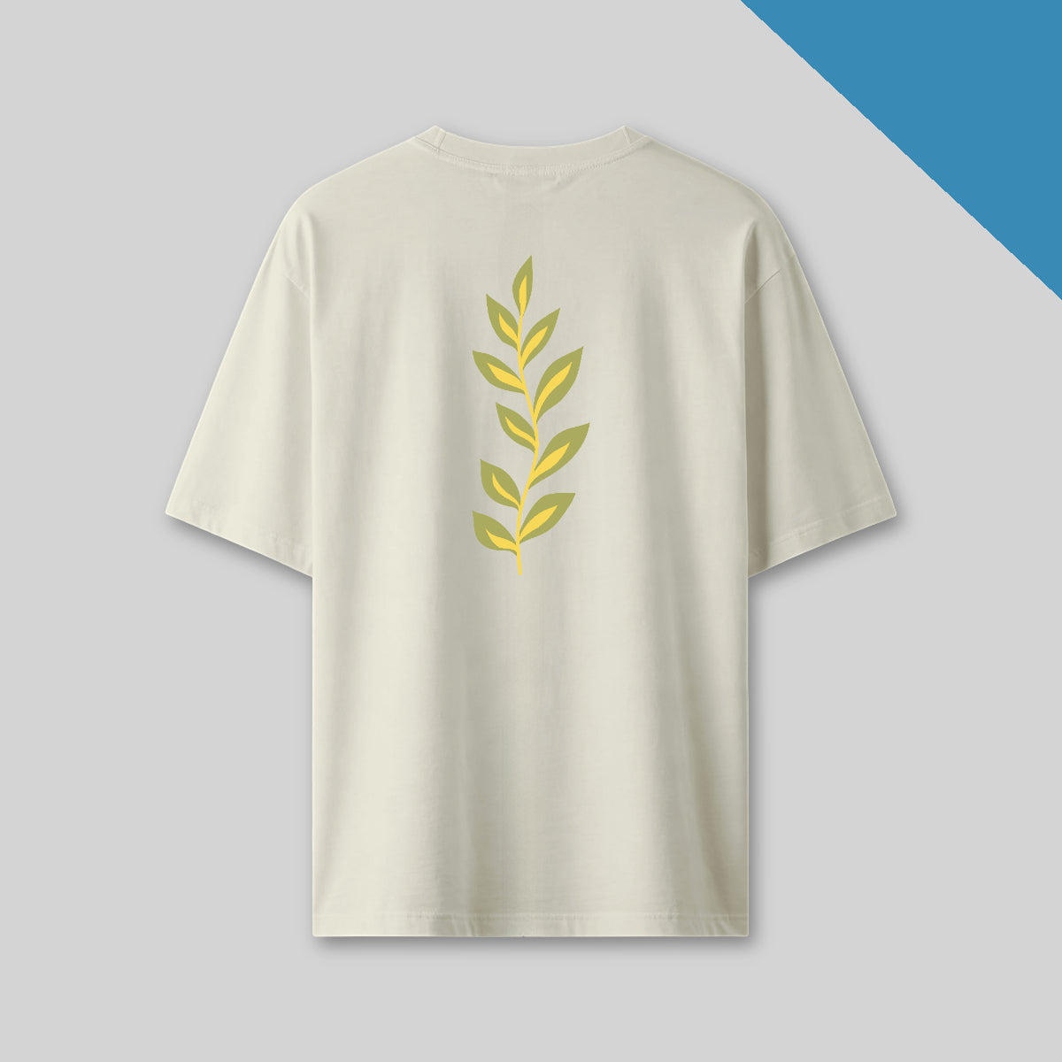 Beige t-shirt with yellow leaf design on a gray background