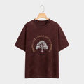 Brown t-shirt with a tree graphic and text on a hanger against a white background