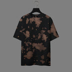 Black t-shirt with brown abstract pattern on a hanger against a gray background