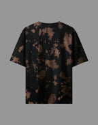 Black t-shirt with abstract brown pattern on a gray background