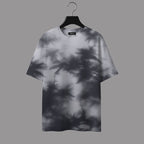 T-shirt with leaf shadow pattern on a hanger against a gray background