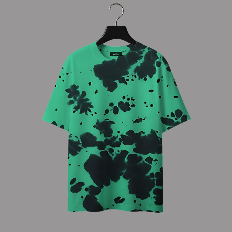 Green t-shirt with black abstract pattern on a hanger against a gray background