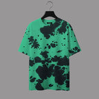 Green t-shirt with black abstract pattern on a hanger against a gray background