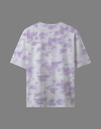 Tie-dye t-shirt with purple and white pattern on a gray background