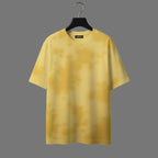 Yellow t-shirt on a hanger against a gray background